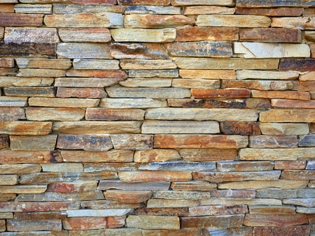 Color stone wall background in warm huesの写真素材