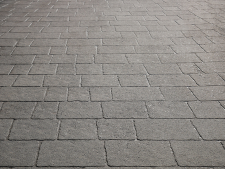 Gray wet concrete pavement slabs in sunlightの写真素材