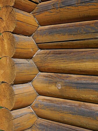Coner with big parallel wooden logs of pine outside, traditional architectural style in mountainous and northern areas of Eastern Europeの写真素材