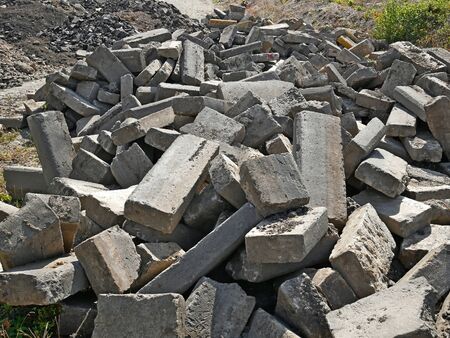 Large pile of old broken concrete blocks that were used in road pavement construction as a secondary raw materialsの写真素材