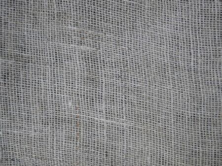 Part of flat surface of the traditional natural handmade sparse cloth, close-upの写真素材