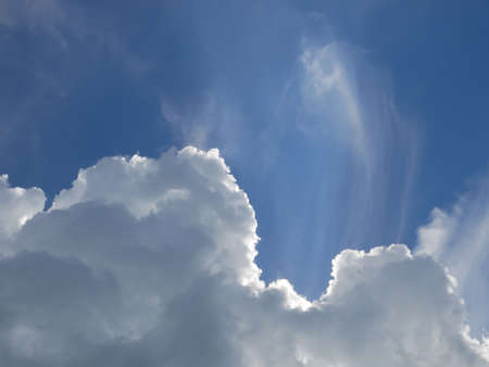Beautiful cloudscape with white clouds on the background of bright blue sky in summertimeの写真素材
