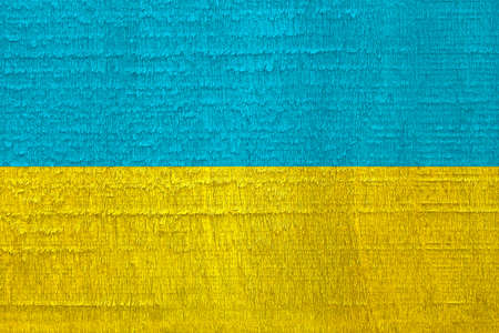 Flag of Ukraine with blue and yellow colors painted on the old dried wooden texture, Ukrainian national patriotic symbol of Independence, sovereignty and struggle in warの写真素材