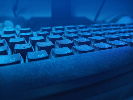 Detail of keyboard in low lighting in bluish hues, close-upの写真素材