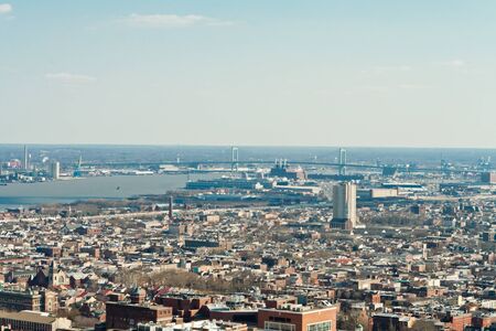 South Philadelphia as seen from downtown.  Woodrow Wilson Bridge in background, I-95 in front of that.  South Philly is mostly older brick row homes.の写真素材