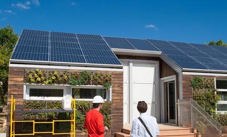 Solar construction workings looking at the roof.  Plants are from a gray water recovery system.のeditorial素材