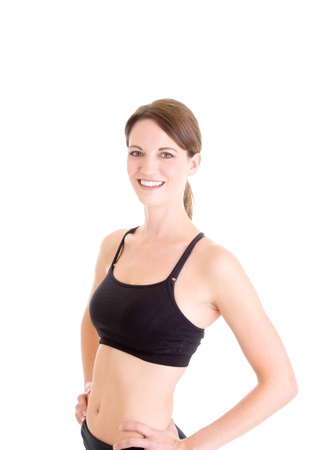 Slender young Caucasian woman in sports bra isolated on whiteの写真素材