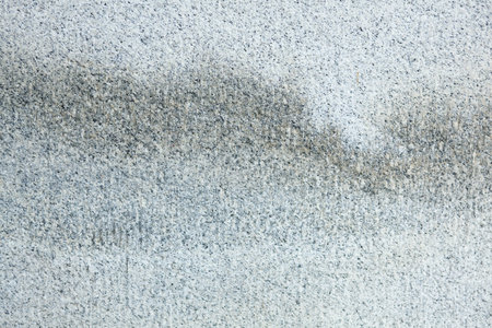 Grungy white and gray stained granite stone useful for a background