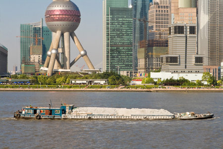 Barge on the Huangpu River which runs through downtown Shanghai.  Shot from Puxi and shows Pudong...