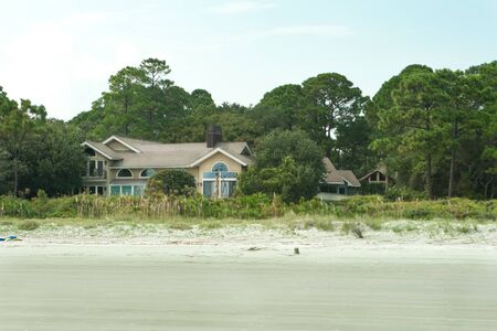 Modern single family home on the beach at Hilton Head Island, South Carolina. Sand dunes and beach in the foreground.のeditorial素材