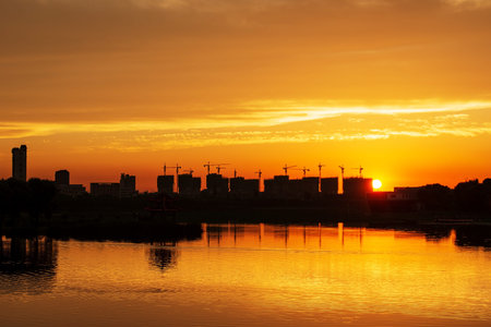 Sunset lake light and tower crane