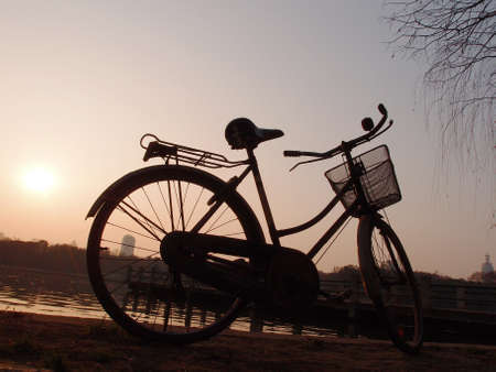Sunset bike, at the water s edge    の写真素材