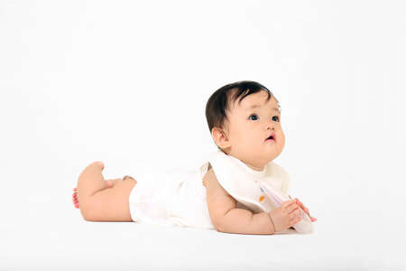 The whole body of a baby girl doing a high and highの写真素材