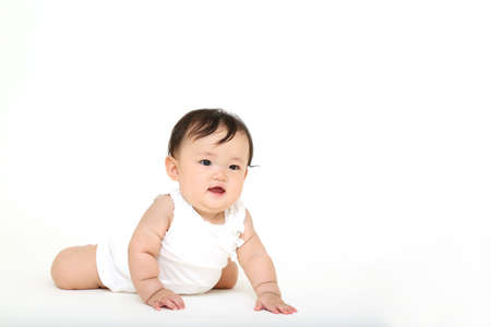 Oblique front of a baby girl doing a high-highの写真素材