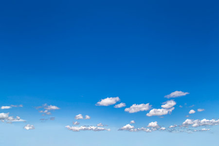 Blue sky with sheep clouds floating near the horizon. Background Materialの写真素材