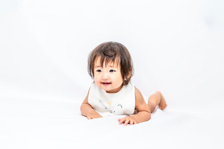 Oblique front view of baby girl crawlingの写真素材