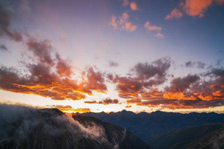 The golden snow mountain panorama of sunrise and sunset in Western Sichuan Chinaの写真素材