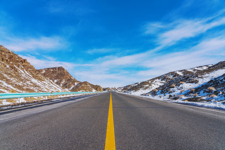 Highways, Snowy Mountains, and Winter Snow Scenery in Xinjiang Uygur Autonomous Region, Chinaの写真素材