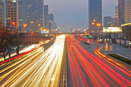 Light trails on the background of the modern architecture in Shanghai, Chinaの写真素材
