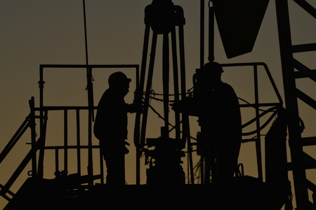 field oil workers at workの写真素材