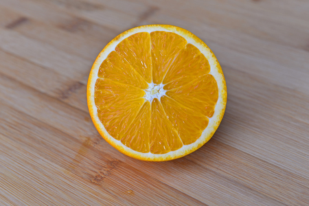 Orange isolated in wooden backgroundの写真素材