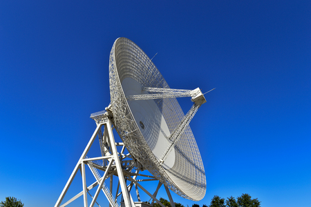Array of satellite dishes or radio antennas against sky. Space observatory.の写真素材
