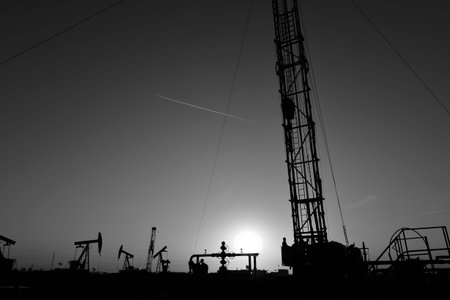 The oil workers are working at oilfieldの写真素材