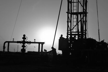 The oil workers are working at oilfieldの写真素材