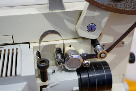 A close?up view of an old rusted metal film reel with coiled analog film, showcasing retro cinematic texture and aged details from traditional movie projection equipment.