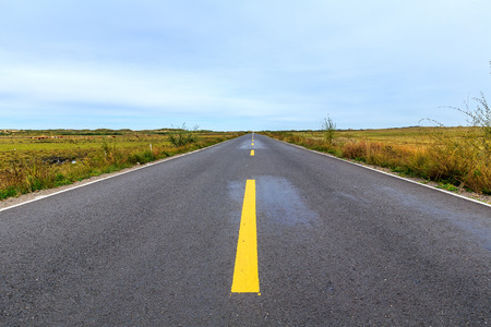 Highway on the dam on the grasslandの写真素材