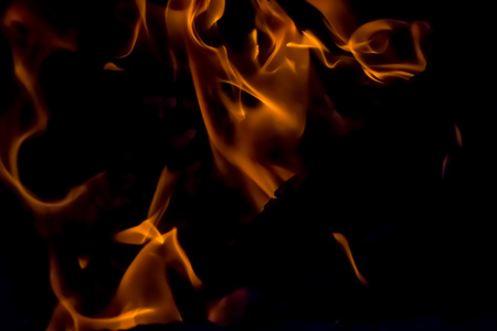 A beautiful horizontal texture of a burning fire on a black background with sparks is in the photoの写真素材