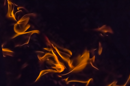 A beautiful horizontal texture of a burning fire on a black background with sparks is in the photoの写真素材