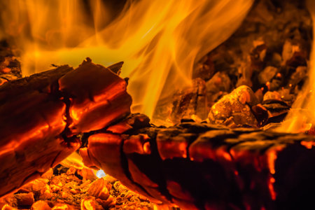 A beautiful horizontal texture of a burning fire on a black background with sparks is in the photo