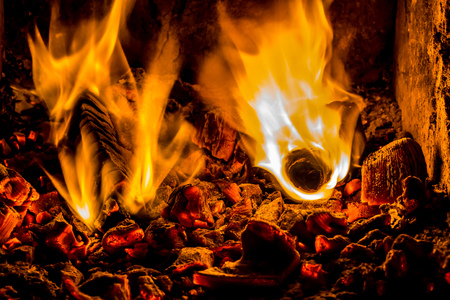 A beautiful horizontal texture of a burning fire on a black background with sparks is in the photoの写真素材
