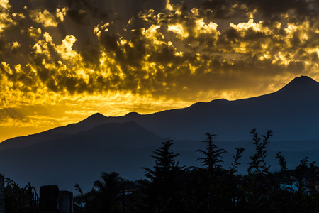 A beautiful sunset in the mountains in the gold clouds in Sicily volcano Etna we see in the photoの写真素材