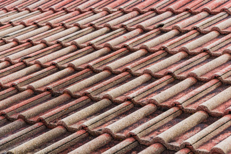 A beautiful horizontal texture of part of an old brown roof of clay tiles