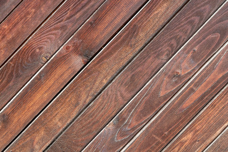 A beautiful angle texture of old yellow and brown boards with knots is in the photo