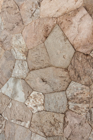 A beautiful texture of path of yellow natural stones on the is in the park. Vertical