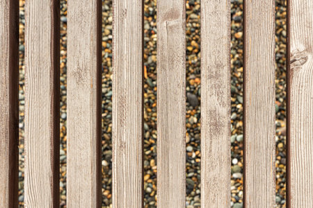 A beautiful texture of brown vertical boards with knots is on the yellow blurred background
