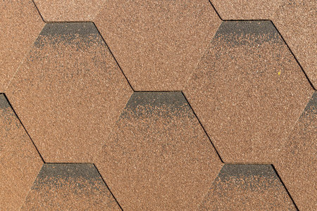 A Horizontal texture of a brown shingles roof