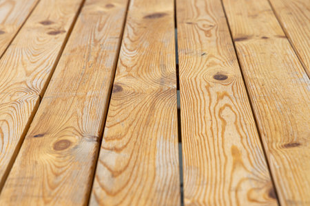A Horizontal texture of yellow board table with knots and resin painted with impregnation for wood