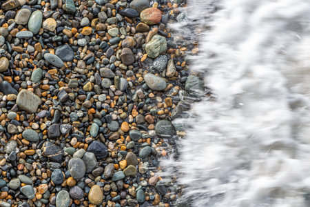 A Beautiful texture of colorful smooth stones is on the beach by seaの写真素材