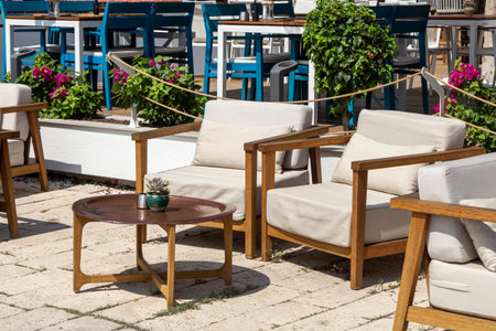The brown wooden table with two white chairs are outsideの写真素材