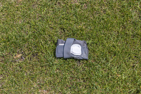 The gray wrist guard on the green grass background