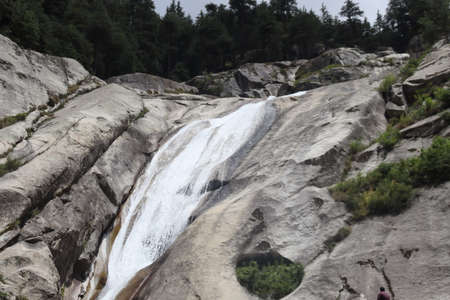 A waterfall is a river or other body of water's steep fall over a rocky ledge into a plunge pool.の写真素材