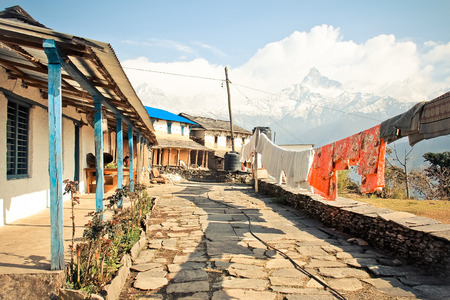 Village in Nepal with a viet to Mt. Machapuchareの写真素材