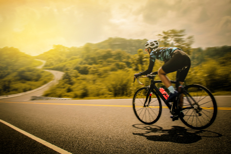 Women cycling mountain road bike in the morningの写真素材