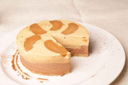 Slicing a Victoria sponge cake revealing the jam and buttercream fillingの写真素材