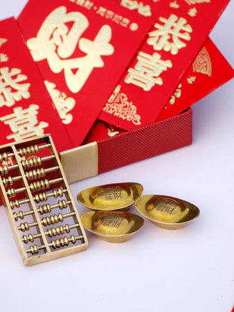 Red envelopes, abacus and gold ingots on white backgroundの写真素材