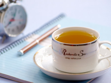 Pen, books and tea on tableのeditorial素材